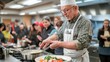 © Sampao - A chef teaching a cooking class, demonstrating how to prepare a dish while participants watch and take notes.