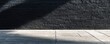 © LabirintStudio - Shadow on black brick wall and concrete