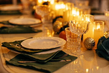 A cozy stylish living room with a covered table and a decorated Christmas tree with a garland.