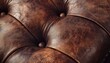 © musa - Close-up of brown leather upholstery with button tufting.