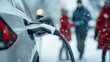 © peera - Diverse Family Charging Electric Vehicle in Snowy Urban Environment, Capturing Moments of Togetherness and Sustainability Amidst Winter's Chill