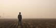 © kiimoshi - A solitary figure stands in a foggy field, evoking feelings of introspection and solitude against a blurred landscape.
