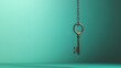 © Naturalis - Antique Key Pendant Hanging Against Teal Green Background