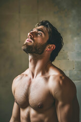 Wall Mural - A shirtless man with a beard looking up at the sky