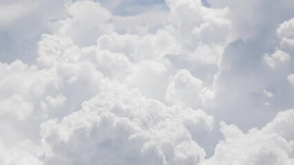 Wall Mural - view from plane over blue sky with white Fluffy clouds while flying through in sunny summer time.nature blue sky cloud and sun for Clean Environment, save energy or transportation holiday concept. 
