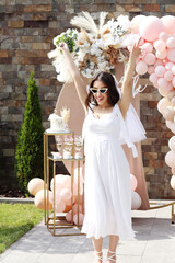 the bride dances. bride hands up.Ceremony celebration party concept.Bachelorette. woman 25s in beautiful white wedding dress and glasses.emotional bride.bride to be