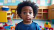 © wolfhound911 - A 3 year old Black child standing alone in a bright kindergarten classroom, looking confused, with colorful toys scattered around. The child's wide eyes show uncertainty as they stand apart from the