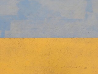 A simple abstract composition featuring two bold colors, yellow and blue, divided horizontally with minimal texture