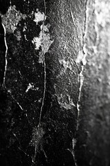 Poster - A close-up view of a textured black surface with subtle cracks and unique patterns, perfect for backgrounds or artistic projects.