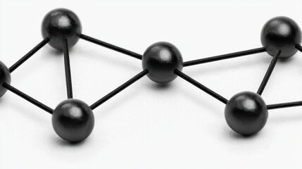 Poster - A close-up view of a minimalist black structure featuring interconnected balls and lines, symbolizing networking, connection, and creativity.