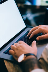 Fototapete - Close up view of male hands on keyboard of laptop computer, cropped view with soft focus of internet user using technology for online communication. Online banking operations, mock up blank screen