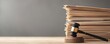 © Cheewynn - Gavel on wooden base with voluminous legal files, representing complex legal cases and justice system challenges
