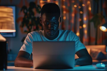 Poster - A person sits at a desk with a laptop open, focused on their work