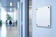 © Denis - A mock up of a blank glass nameplate design, The sign plate is mounted on the wall near the interior door of the office , clinical