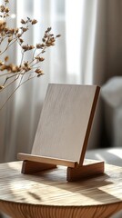 Wall Mural - A minimalistic wooden stand displaying a blank canvas in a softly lit room with natural light streaming through sheer curtains during a calm afternoon