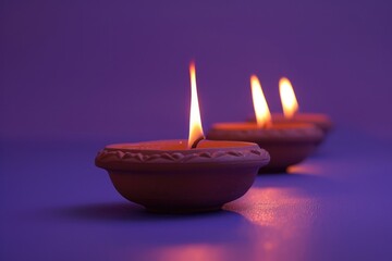 Wall Mural - Three lit candles placed in a row on a table, ready for use