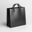 © Monty - A sleek black shopping bag with matte finish and durable black handles stands out on a simple gray background scene.