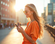 © Radorog. - A bright beautiful woman is typing on her phone while walking down the street