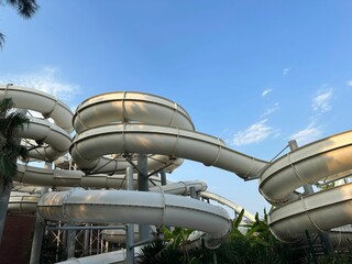 Poster - Water slide against blue sky, low angle view