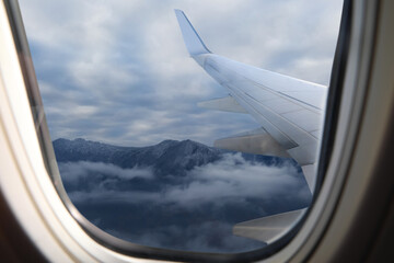 Wall Mural - Airplane flying over mountains, beautiful view from window