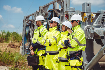 Team Engineers and Technicians Managing Wind Turbines Outdoors, Focused on Renewable Power Generation and Environmental Conservation. Sustainable Energy and Industrial Solutions for a Greener Future.