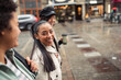 © Davor - Three diverse female friends walking together on city street