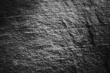 Monochrome black and white bumpy stone wall for abstract background and texture for interior or exterior design. Beautiful patterns, space for work, banner, wallpaper close up.