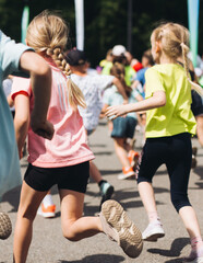 Wall Mural - Children marathon runners crowd, young teen sportsmen participants start running in the city streets, crowd of kids joggers in motion, kid group athletes outdoor run, family competition in summer day