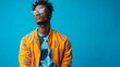 © Cosmic Edge - A bust shot of confident young black male fashion model, posing with athleisure clothes against a vibrant cobalt blue studio background
