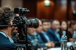 © Alena - A person wearing a business suit sits in front of a camera, ready for an interview or presentation