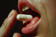 © Babb - A woman is taking a pill in her mouth