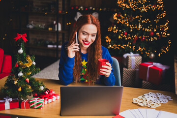 Wall Mural - Photo of attractive woman coffee talk phone netbook dressed blue christmas outfit cozy day light home party decoration interior living room