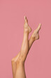 © forma82 - Beautiful feminine long and slim model legs on a pink background.