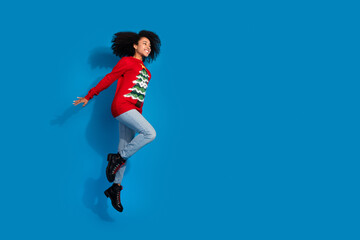 Wall Mural - Photo of cheerful holly jolly woman wear red stylish clothes fly air xmas discount empty space isolated on blue color background