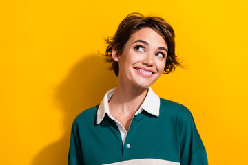 Wall Mural - Photo of pretty young girl look empty space fantasize wear shirt isolated on yellow color background