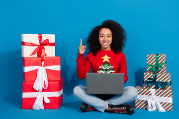 Poster - Full length photo of young lady pile gifts netbook point up eureka dressed red christmas garment celebrate holidays on blue background