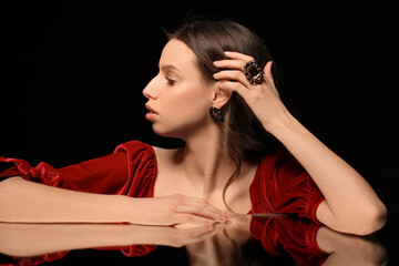 Wall Mural - Woman with beautiful jewelry on black background