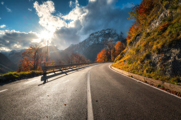 Wall Mural - winding mountain road at sunset in autumn. alps, italy. beautiful curved alpine road, snowy rocks, t