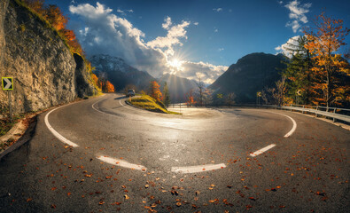 Wall Mural - winding mountain road at sunset in autumn. alps, italy. beautiful curved alpine road, snowy rocks, t