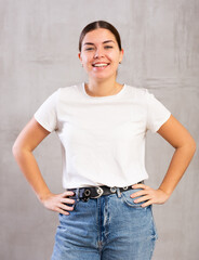 Shot of cheerful smiling young woman posing in casual clothes in studio