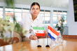 © JackF - Businesswoman arranging the flags of Iran and Netherlands for a presentation and negotiations