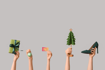 Sticker - Many female hands with shoes, Christmas gift box, decorative fir and credit card on grey background