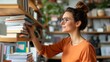 © LifeMedia - A woman wearing glasses selects books from a neatly organized home library, appreciating the joy of reading and lifelong learning, surrounded by tranquility.