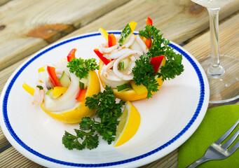 Delicious seafood and vegetables salad with squids, cucumbers, red pepper with olive oil and greek yogurt dressing