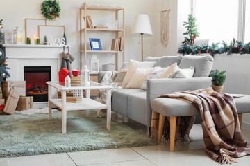 Canvas Print - Interior of living room with sofa, fireplace and Christmas lantern on table