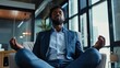 © Budsadee - Corporate professional finding tranquility through meditation, seated on an office chair with eyes closed and deep in peace