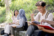 © Gatot - Asian Female Students Giving High Five To Each Other. Students Learning Outside Classroom Together