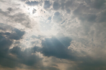 sun in sky with dramatic dark clouds after thunderstorm and rain.