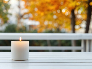 Poster - Burning candle creating cozy atmosphere on empty table outdoors