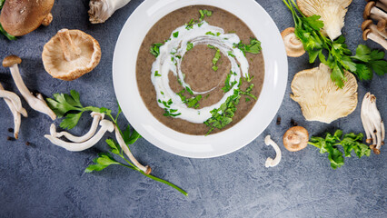 Poster - bowl of mushroom soup with fresh variety of mushrooms